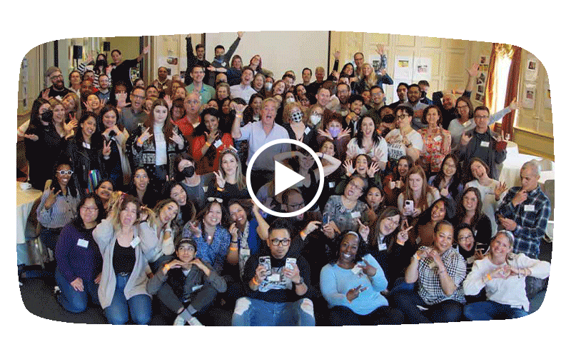 The people of Common Sense pose for a group photo in a large conference room